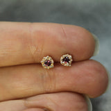 pair of ruby studs on hand in 10k yellow gold