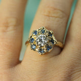 diamond and blue sapphire yellow gold ring on hand