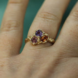 purple, orange and pink sapphire cluster ring in 14k yellow gold on hand