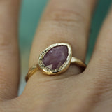 rosecut pink sapphire set in 10k yellow gold on hand