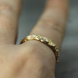 14k yellow gold men's wedding band on hand