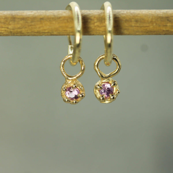 pink sapphires set in yellow gold 