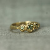 three sapphires set in 14k yellow gold