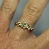 green sapphire engagement ring on hand