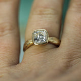 cushion cut lab-grown diamond ring on hand
