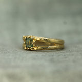 sage green sapphire set in 14k yellow gold