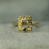 frame inspired gold ring with blue sapphire
