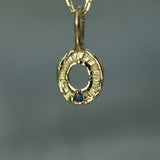 Gold pendant with blue sapphire