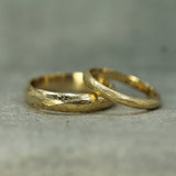 Men's and women's pebble beach bands in 14k yellow gold