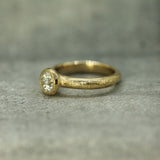 14k yellow gold engagement ring showing textured band