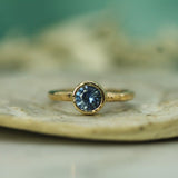bezel set blue sapphire yellow gold ring