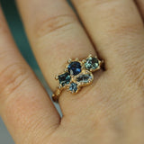 blue sapphire cluster ring on hand