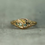 14k rose gold ring with small green sapphires