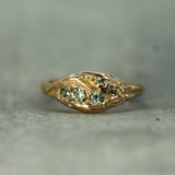 14k rose gold ring with small green sapphires