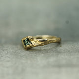 blue princess cut sapphire set in 14k yellow gold