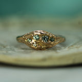 14k rose gold ocean inspired ring with small green sapphires
