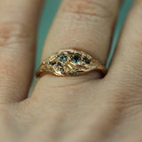 rose gold ocean inspired ring with round green sapphires