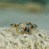 mermaid cluster ring with oval lab-grown diamond and blue sapphires set in 14k yellow gold