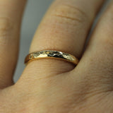 hammered gold band on finger