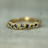 blue sapphire band in 14k yellow gold