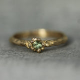 bubbly solid gold ring with green sapphire