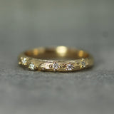 solid yellow gold band with small diamonds