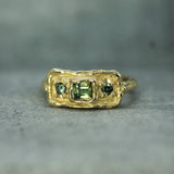 green sapphires set in 10k yellow gold 
