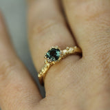 mermaid treasure teal sapphire ring on hand 