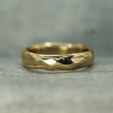 Gold ring with a textured surface on a gray background