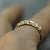 jasper textured band in 14k yellow gold on hand 