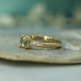 mermaid treasure style 14k yellow gold engagement ring with light green oval sapphire 
