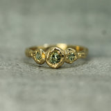 sage green sapphires set in 14k yellow gold 