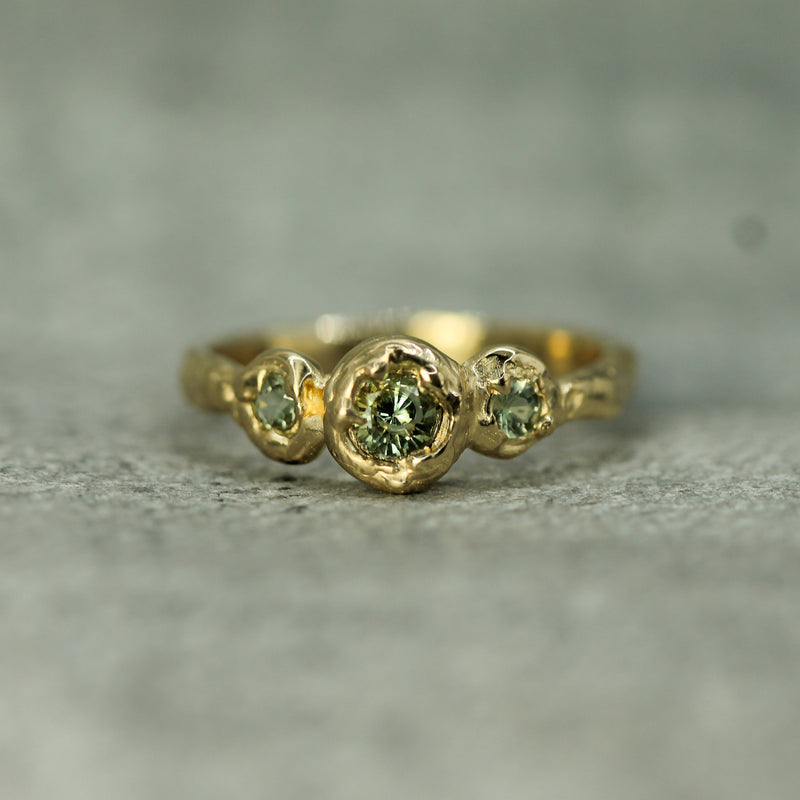 sage green sapphires set in 14k yellow gold 