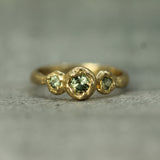 three stone green sapphire engagement ring 