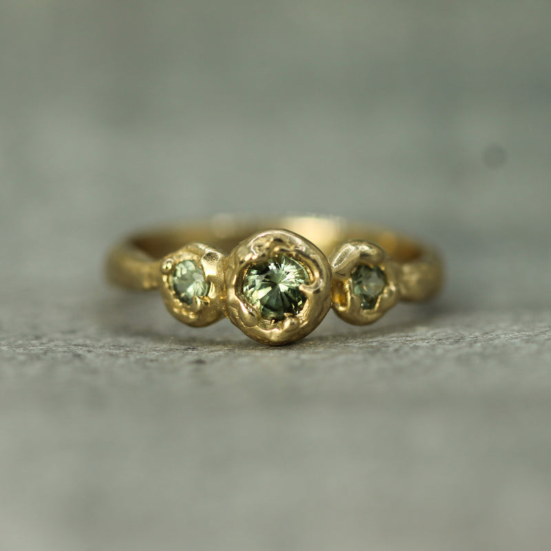 three stone green sapphire engagement ring 