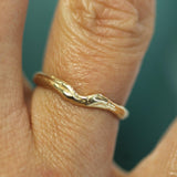 gold ocean inspired band with a subtle wave on hand 