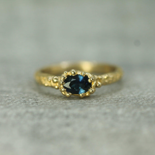 oval deep blue sapphire yellow gold ring 