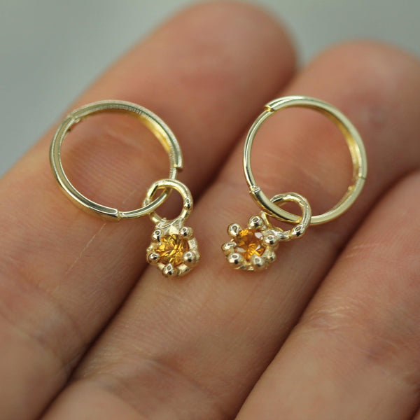 10k yellow sleeper charms with orange sapphire 