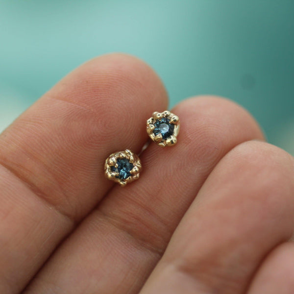 blue sapphire mermaid treasure studs on hand 