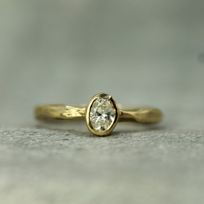 lab grown oval diamond set in solid yellow gold 