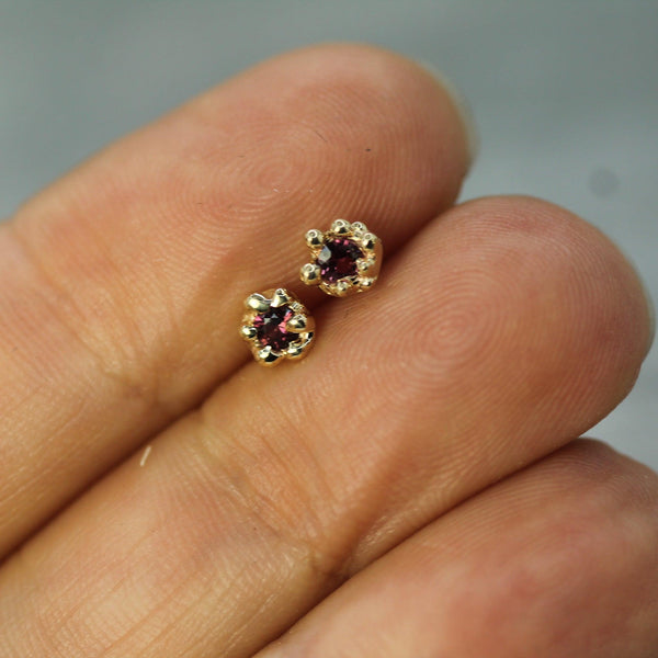 ruby gold studs on hand 