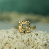 gold ring with small blue sapphire 