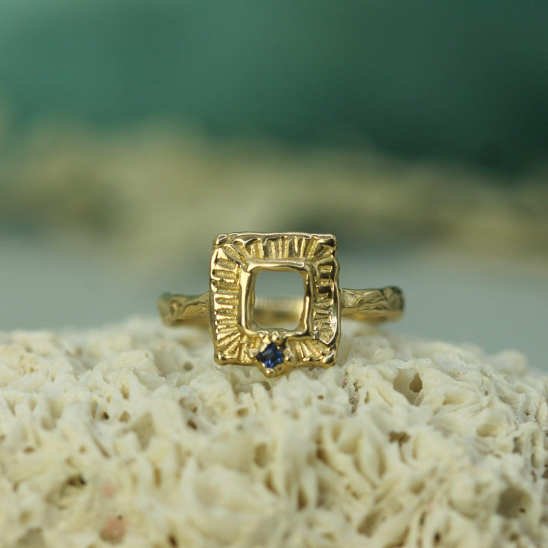 gold ring with small blue sapphire 