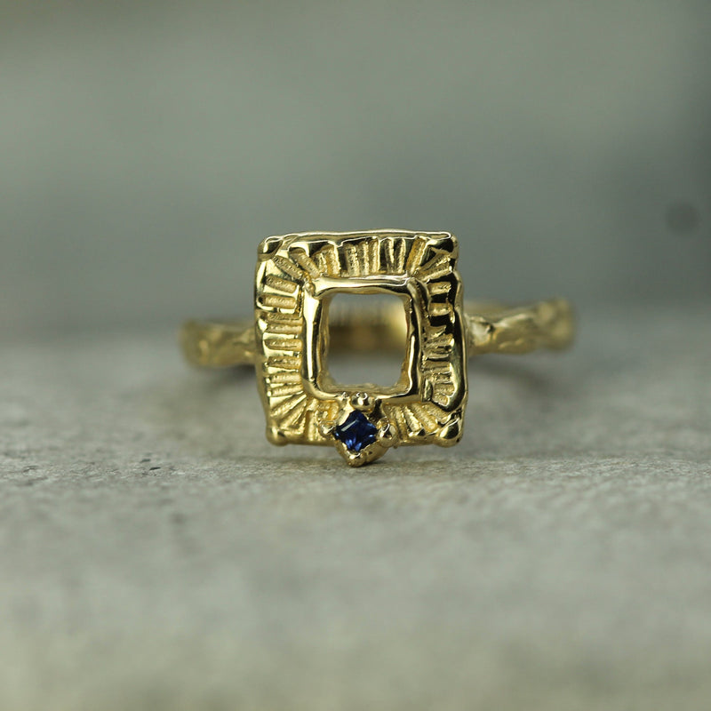 frame inspired gold ring with blue sapphire 