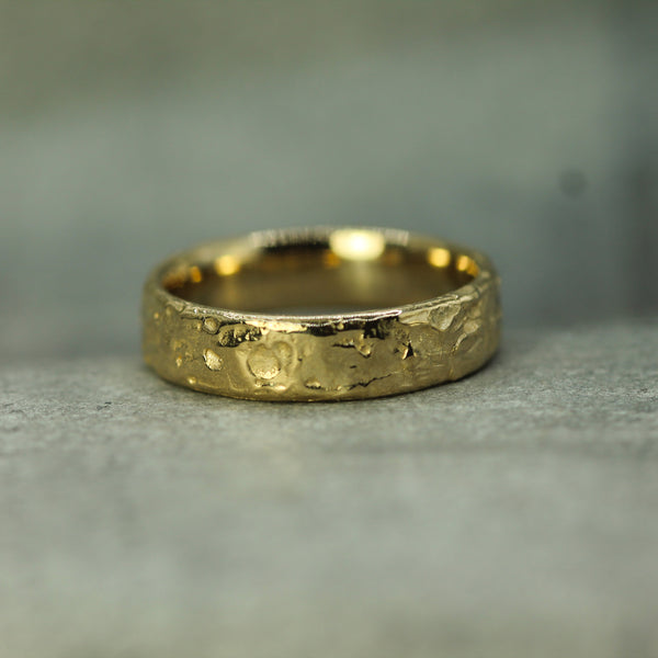 hand carved textured men's wedding band in 14k yellow gold 