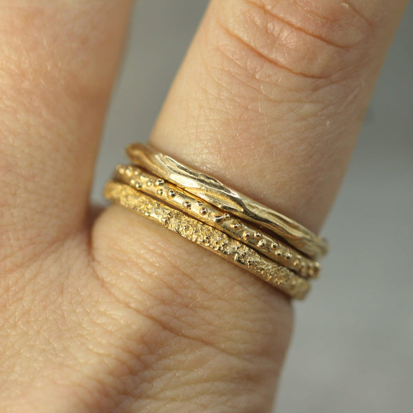 14k yellow gold ring stacked on finger 