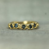 yellow gold band with blue sapphires 