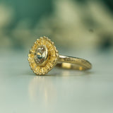 sapphire engagement ring shown side on to show the handcarved detail 