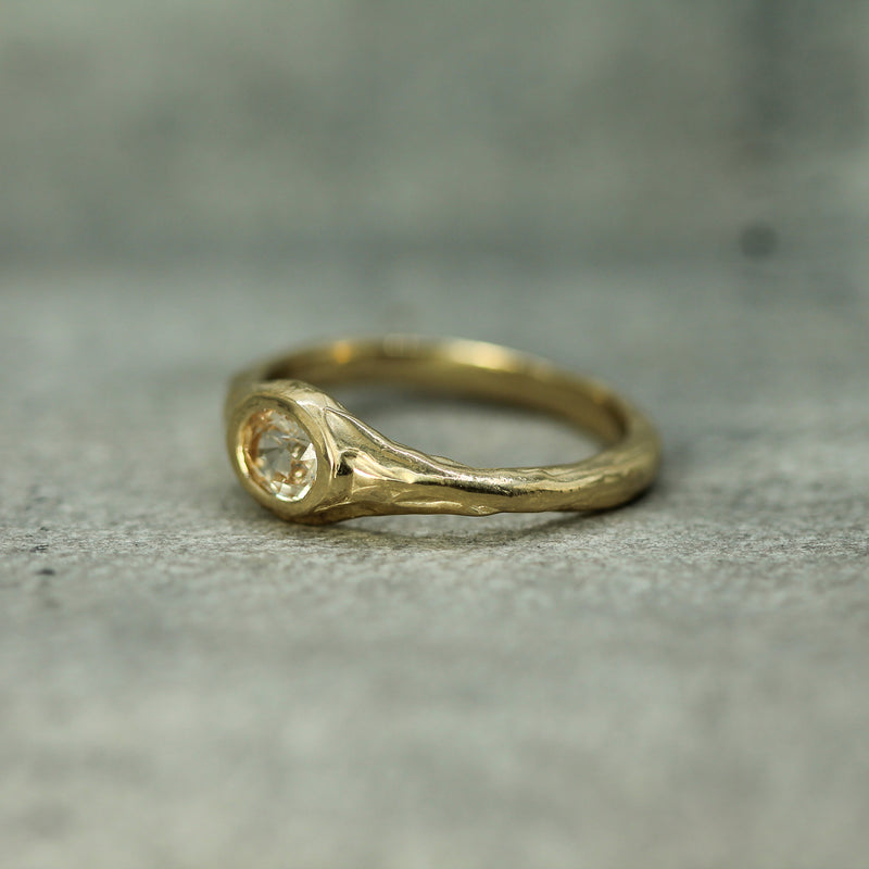 signet style ring in 14k yellow gold showing the textured band 