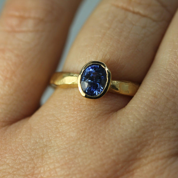 blue sapphire engagement ring on hand 